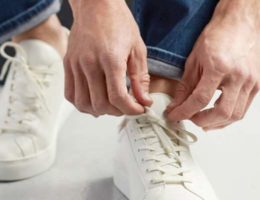 homme portant des baskets blanches